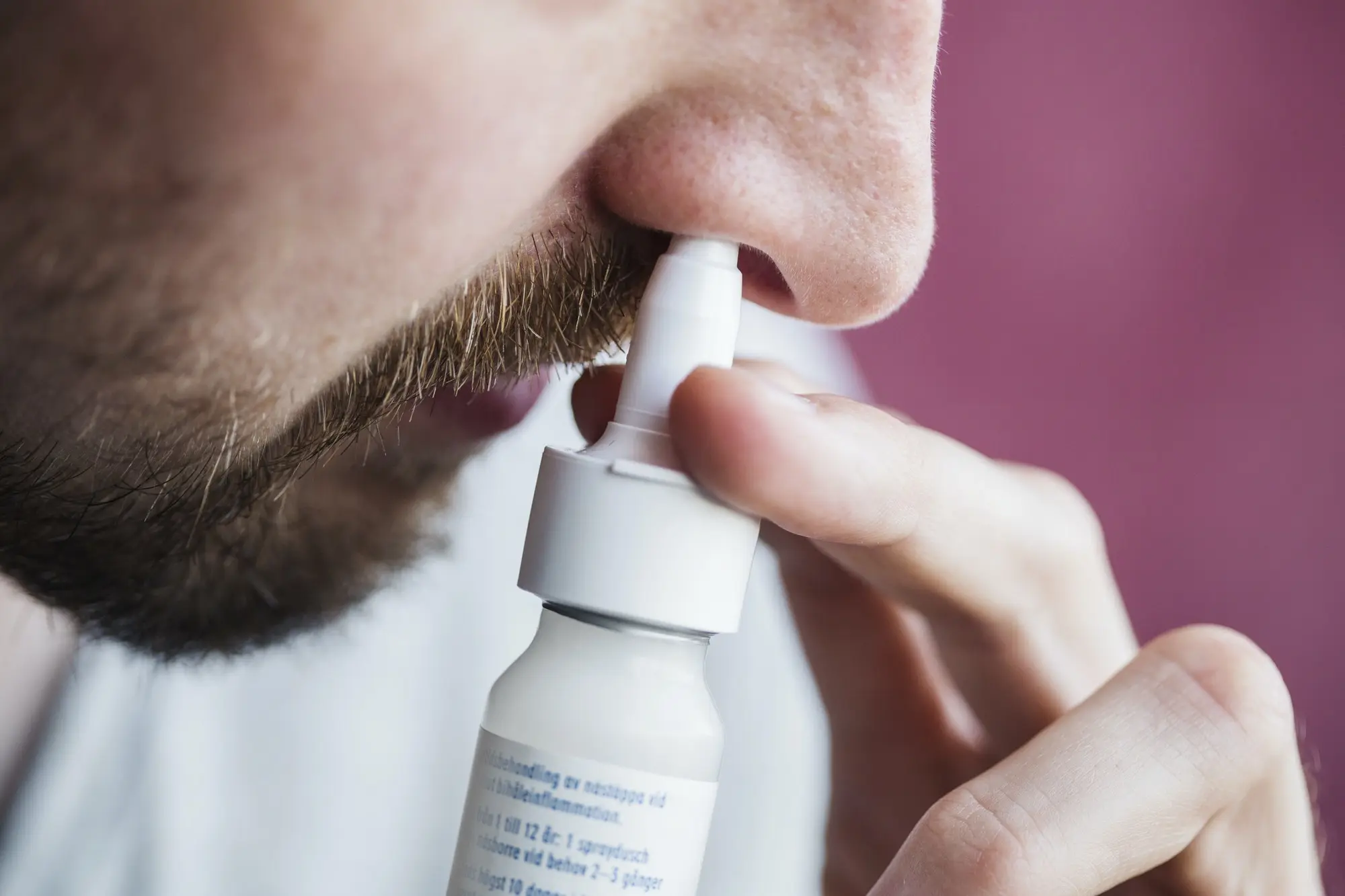 Azelastine – the active drug in anti-allergy nasal sprays demonstrated to have potent anti-viral effect on the Omicron variant of SARS-CoV-2 Close-up of man using nasal spray