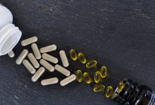 Top view of vitamin supplements on a black surface